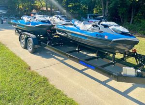 Three Sea-Doo watercrafts on a trailer