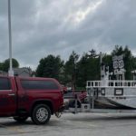 SPecialty boat trailer being towed by a truck